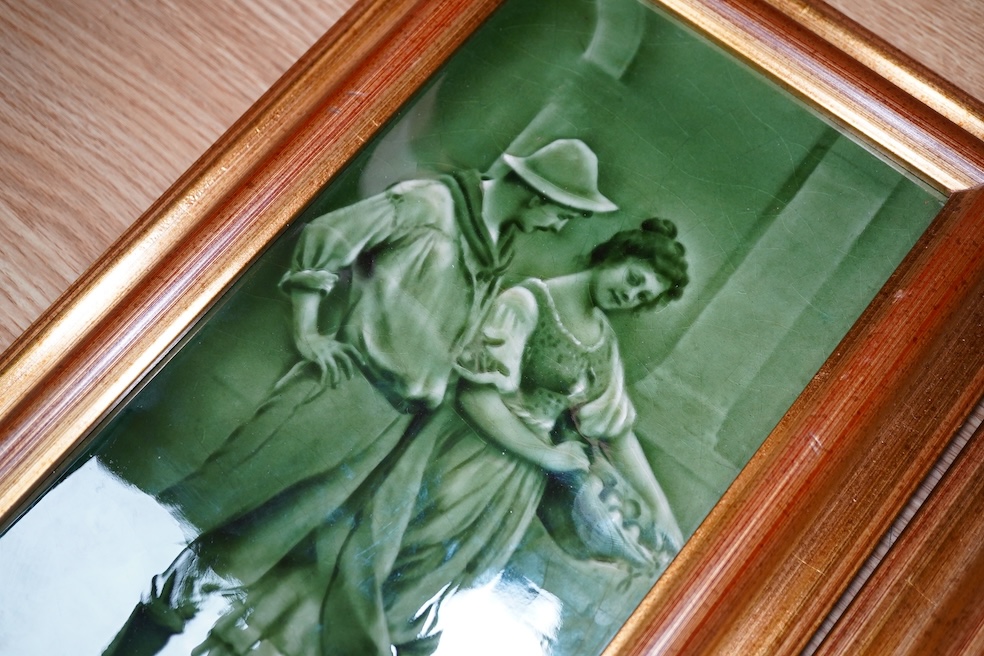 A pair of Craven Dunhill green glazed figurative framed tiles, 29.5cm high, 14cm wide. Condition - good